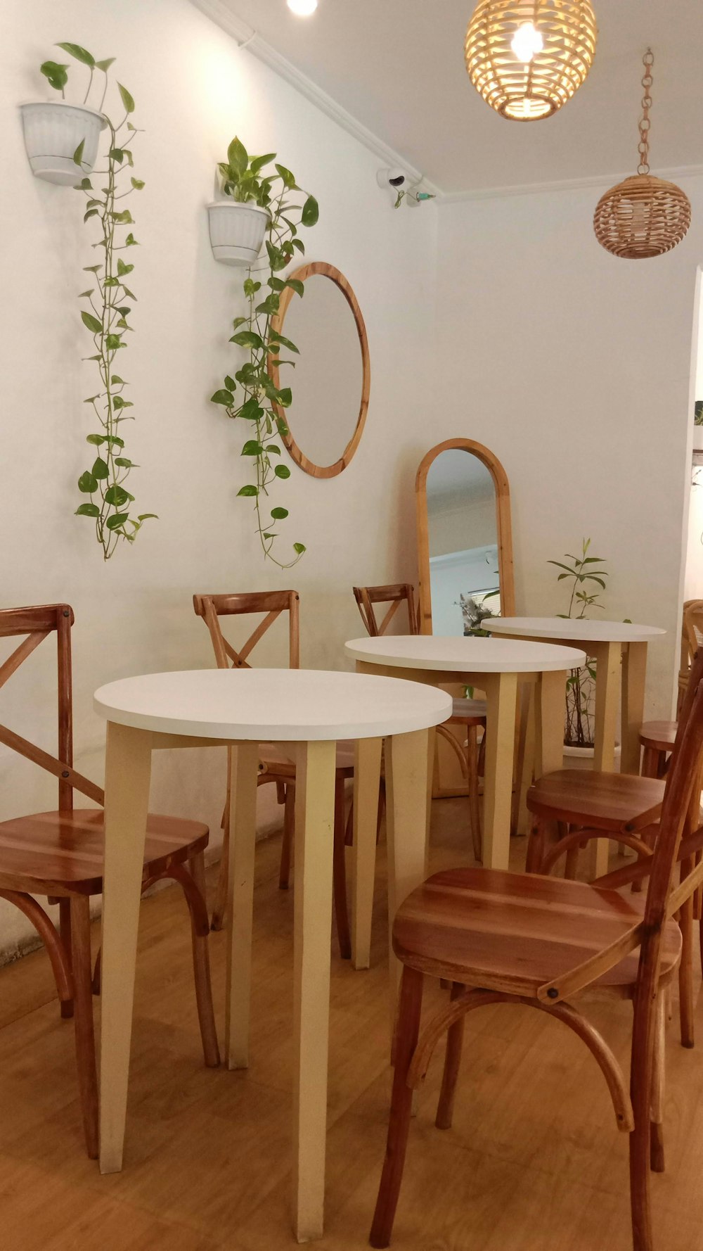 a table and chairs in a room with wooden floors