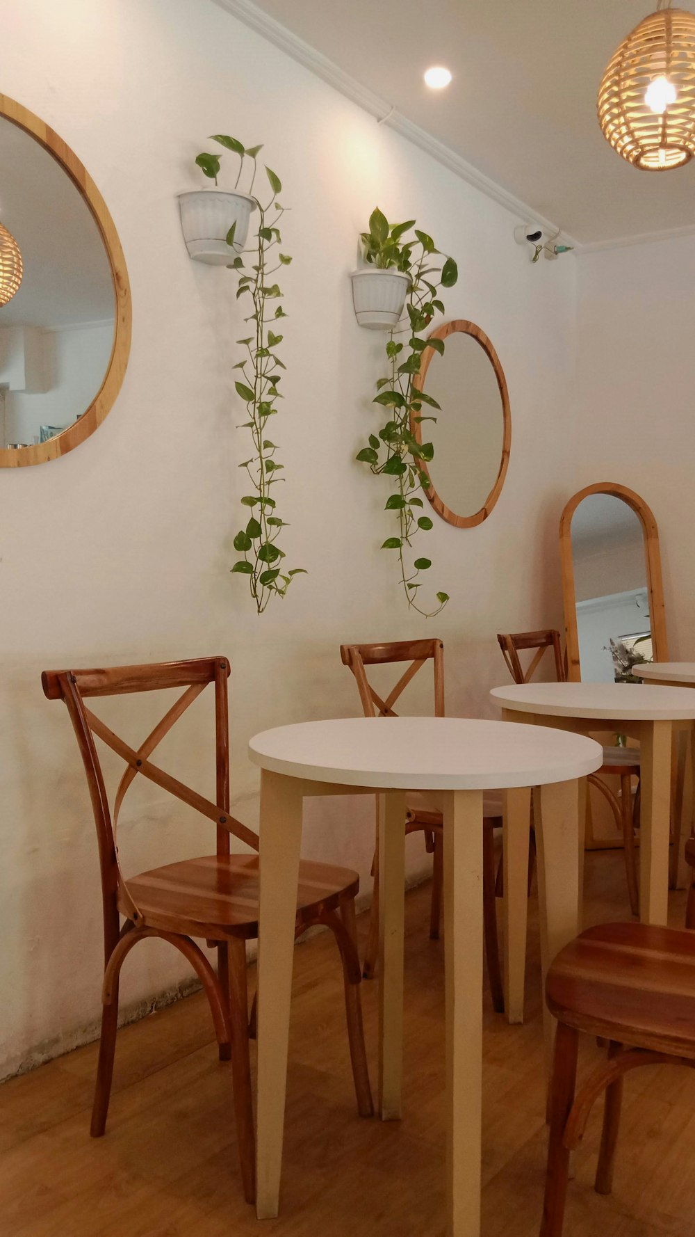 a table and chairs in a room with mirrors on the wall