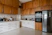 a kitchen with a refrigerator, stove, microwave and cabinets