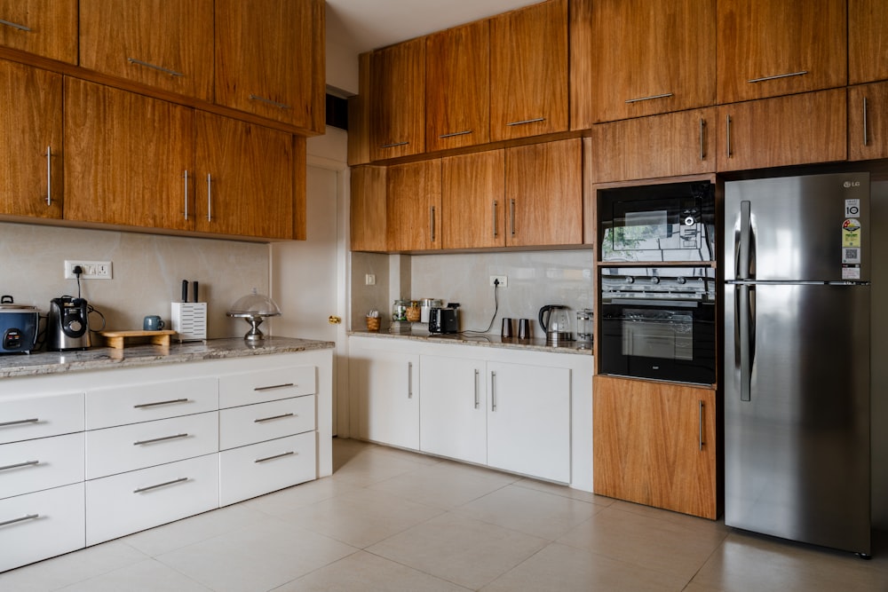 a kitchen with a refrigerator, stove, microwave and cabinets