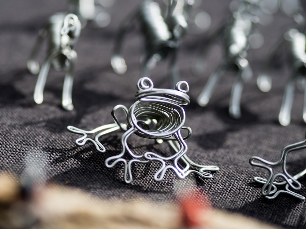 a close up of a group of metal frog figurines