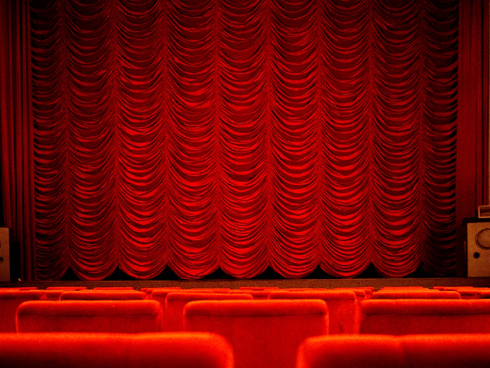 Theater with red curtains and seats, similar to Turks and Caicos Film Festival screenings