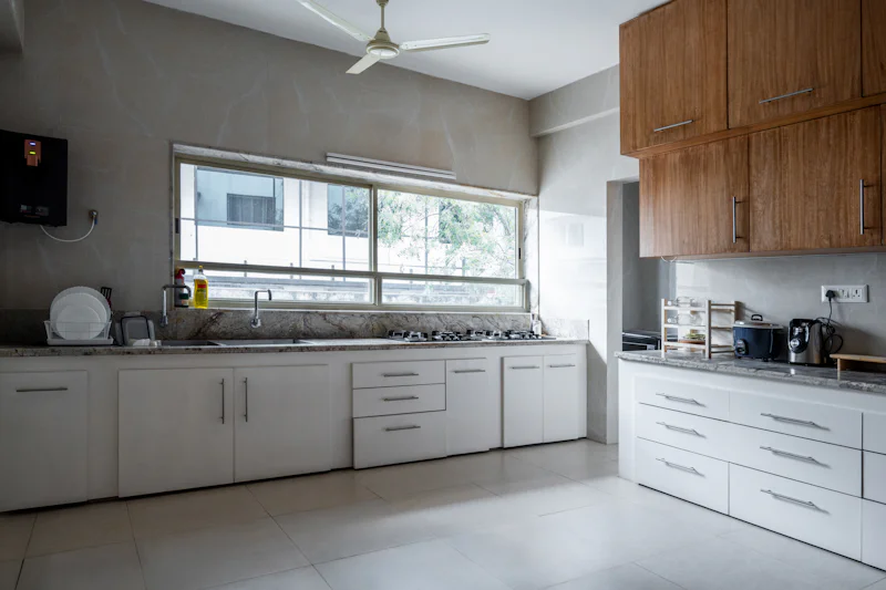 Kitchen with white cabinets and a large window