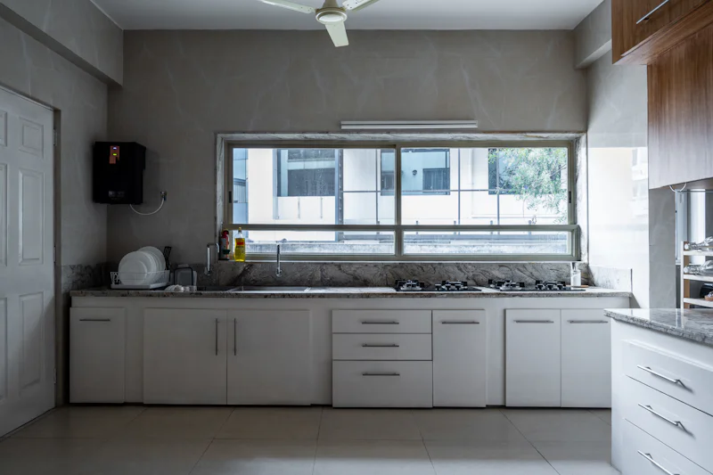 Stove top oven next to a window