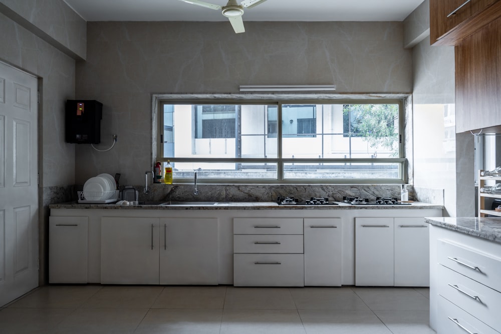 a kitchen with a stove top oven sitting next to a window