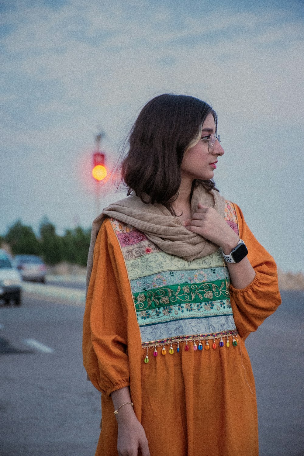 a woman standing on the side of a road