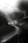 a black and white photo of a river in the mountains