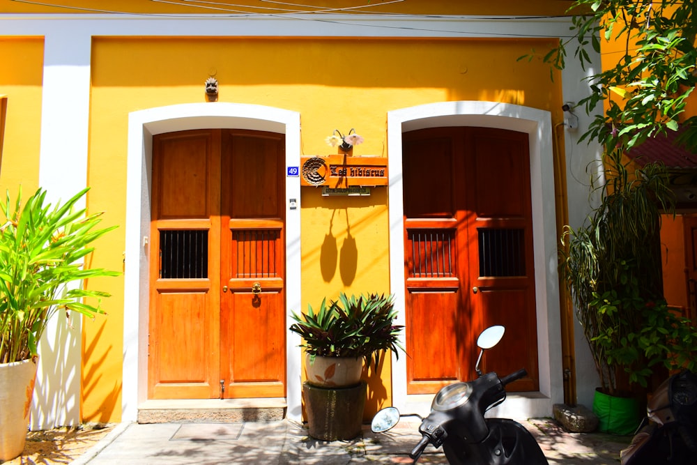 a motorcycle parked in front of a yellow building