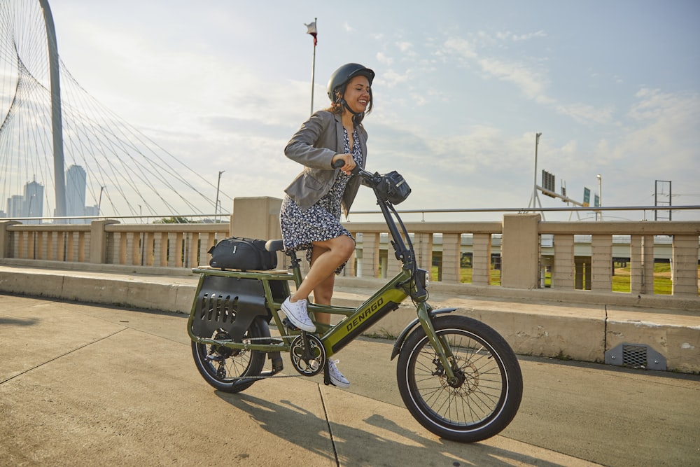 a woman is riding a bike on the street