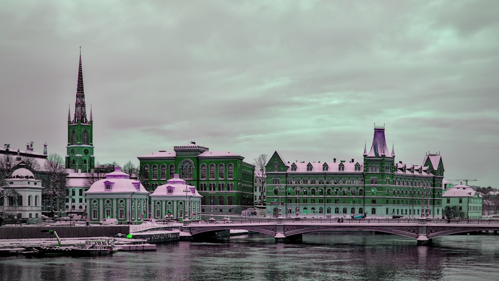 a bridge over a body of water with buildings in the background