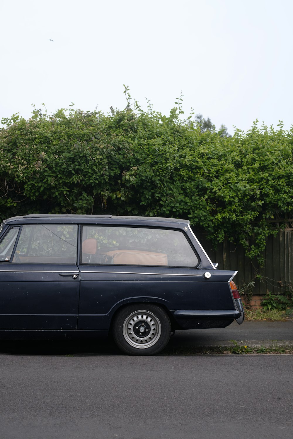 a blue car parked on the side of the road