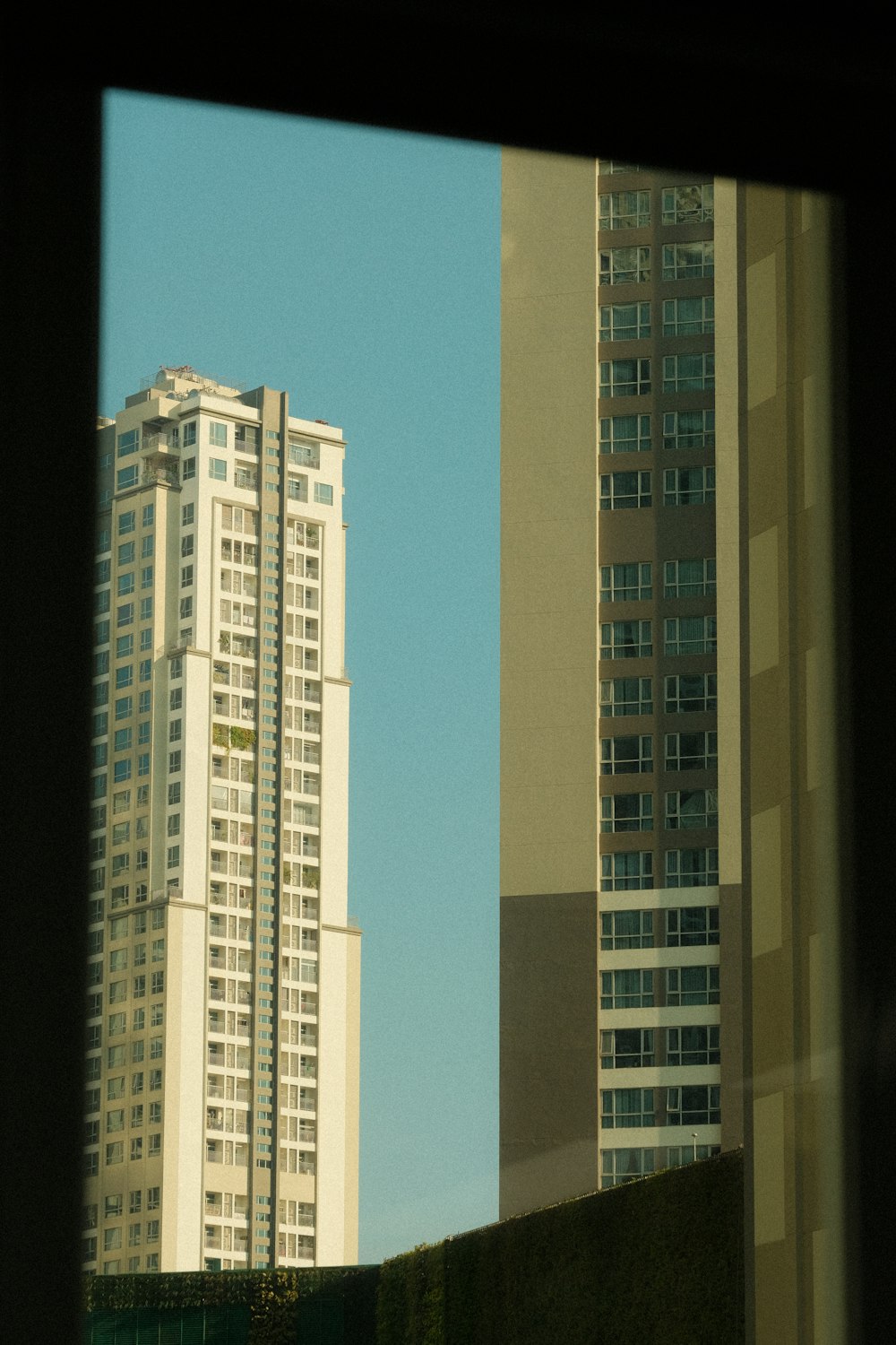 a view of two tall buildings from a window