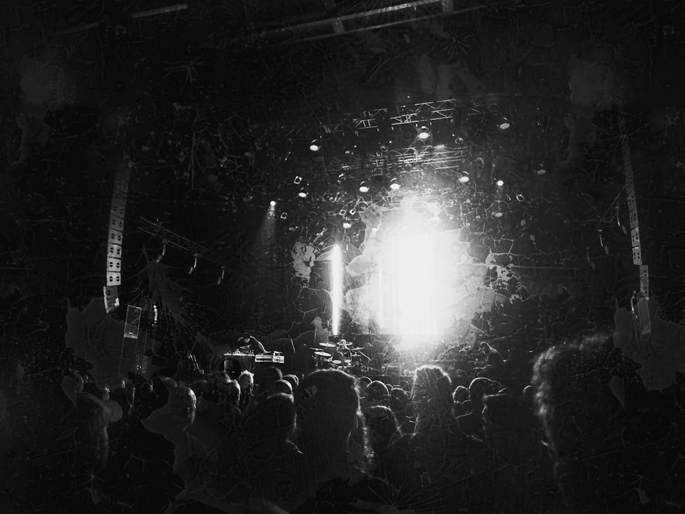 a black and white photo of a crowd at a concert