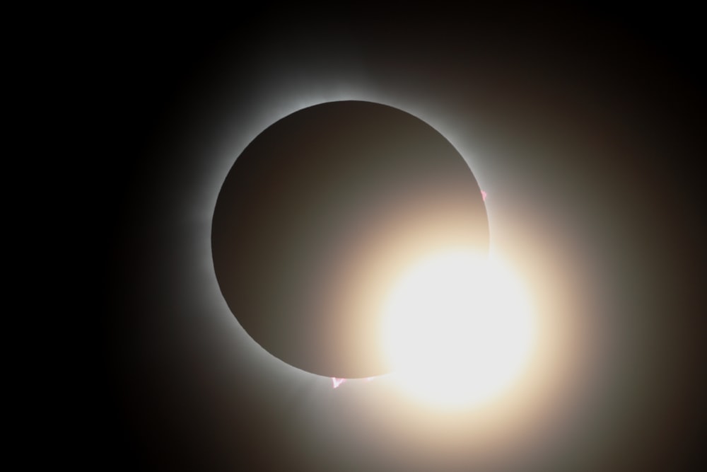 a solar eclipse is seen in the dark sky