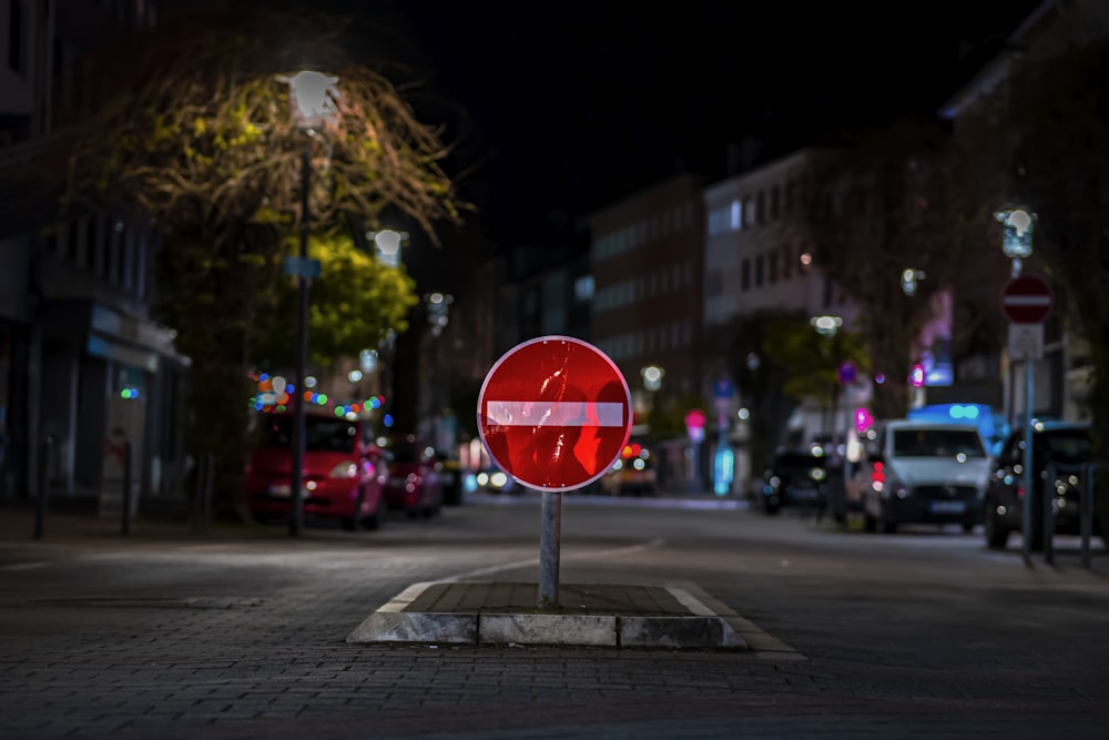 a red stop sign sitting on the side of a road