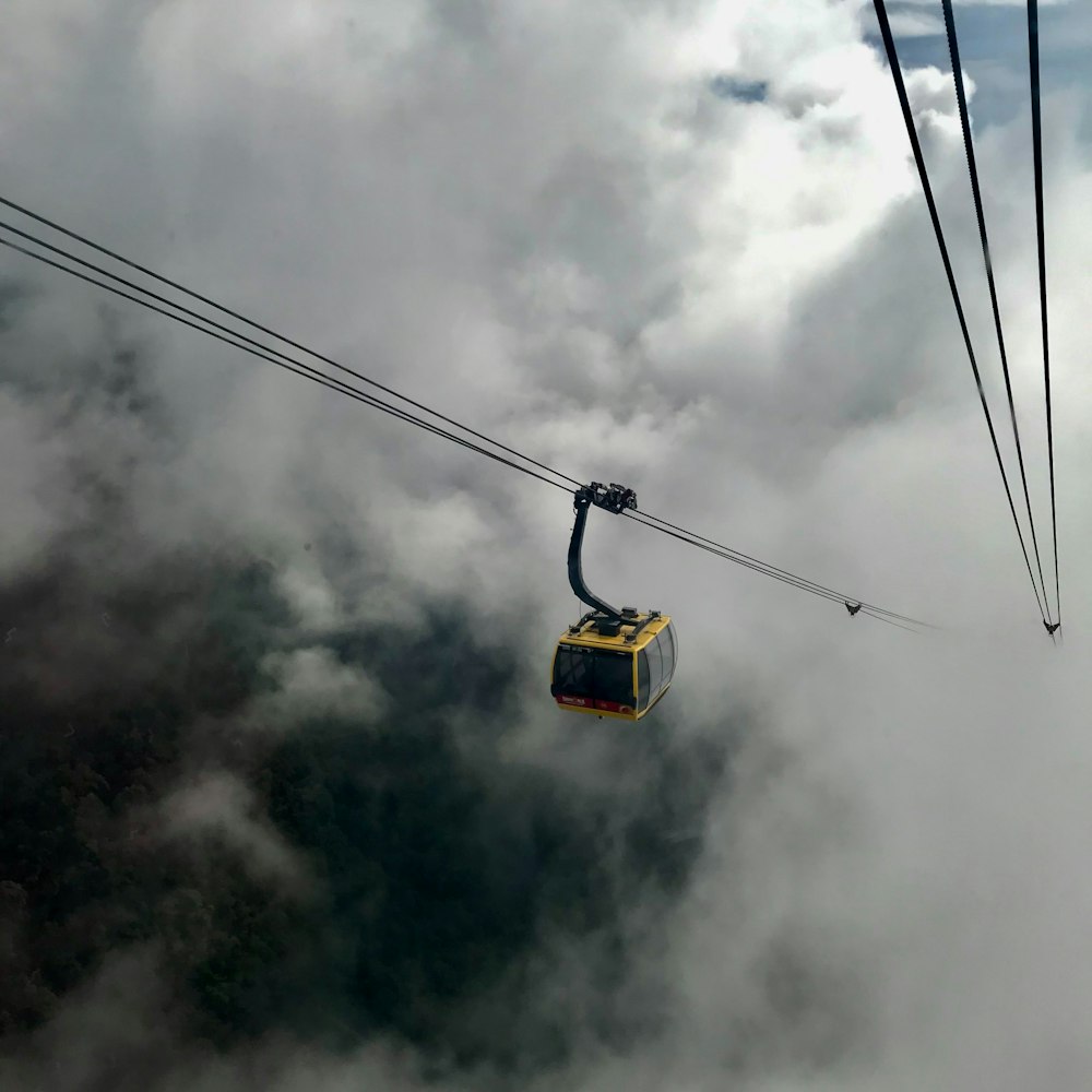 a cable car in the sky above the clouds