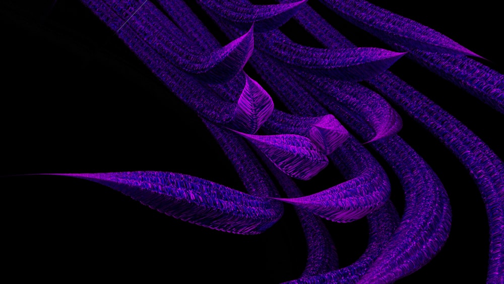 a bunch of purple leaves on a black background
