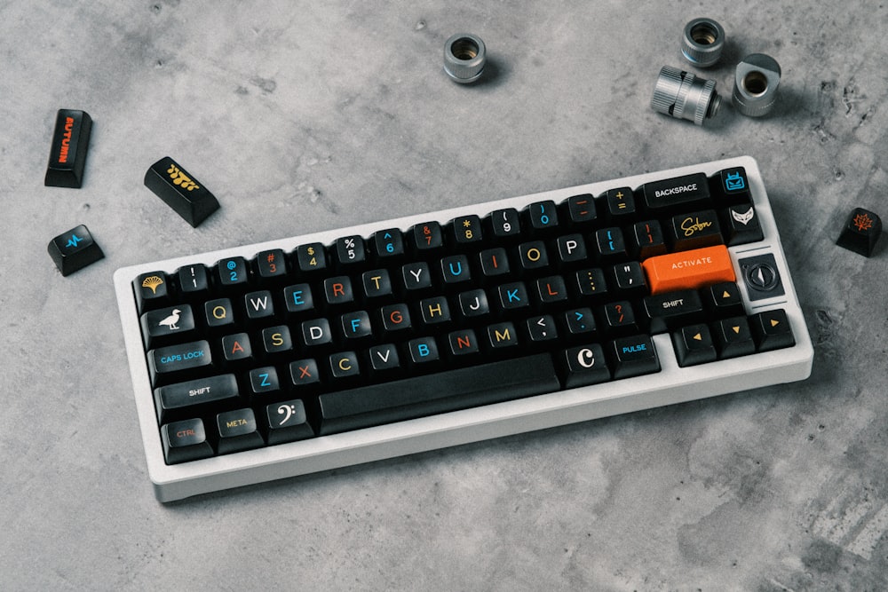 a black and white keyboard with orange keys
