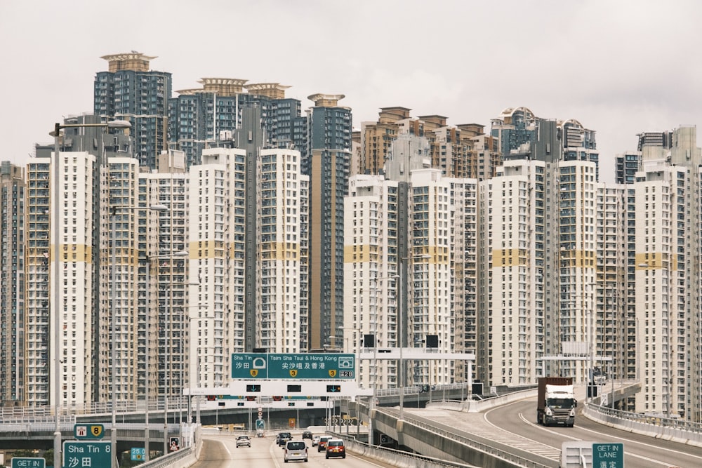 a highway with a bunch of tall buildings in the background