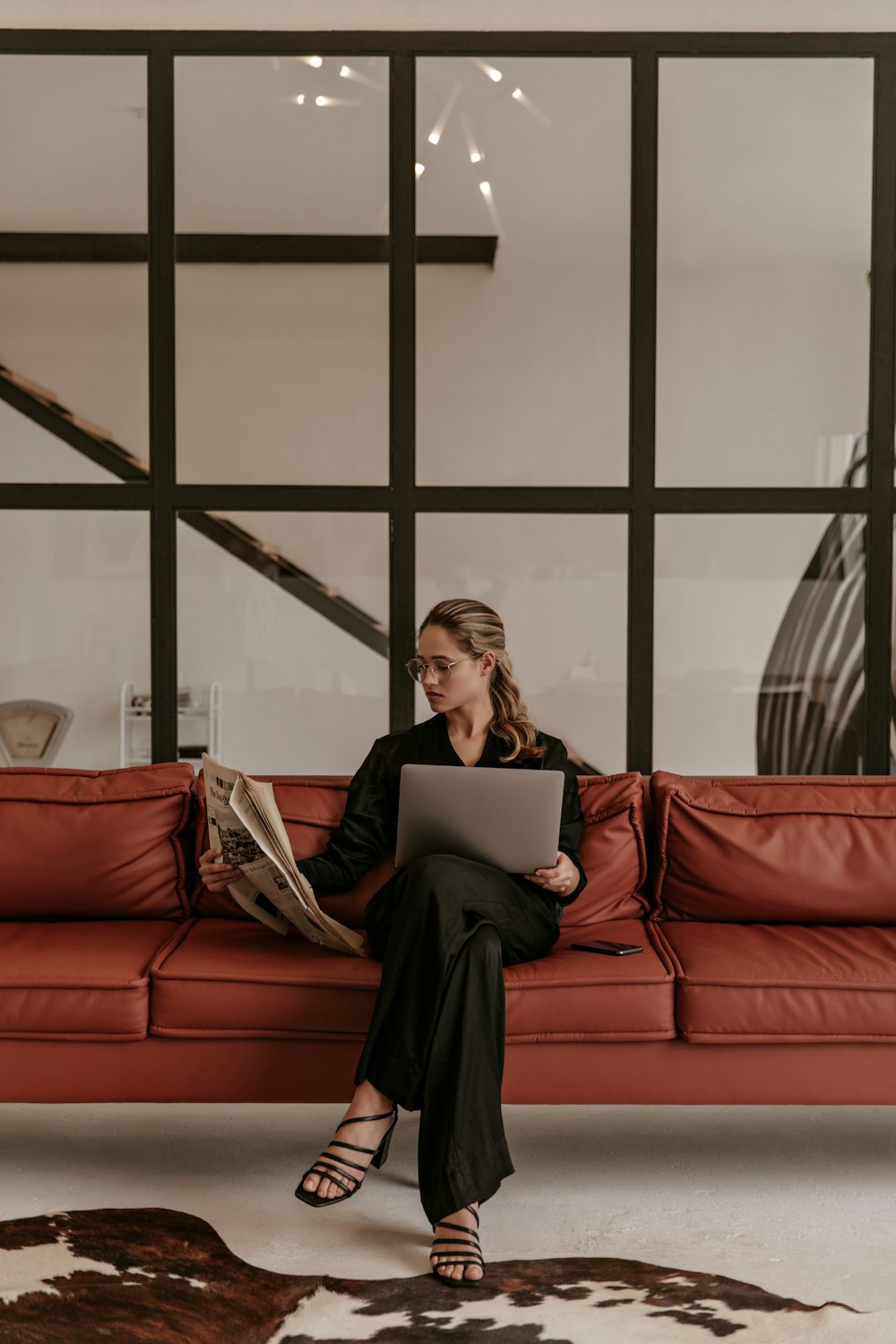 a woman sitting on a couch with a laptop