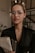 a woman wearing glasses holding a folder