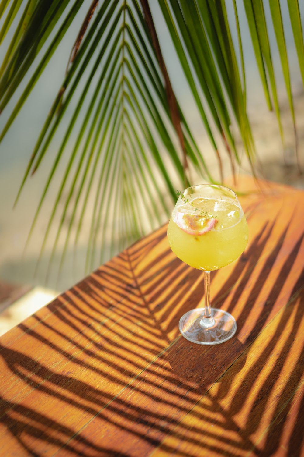 a yellow drink sitting on top of a wooden table