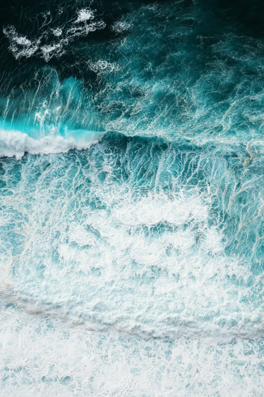 a person riding a surfboard on a wave in the ocean