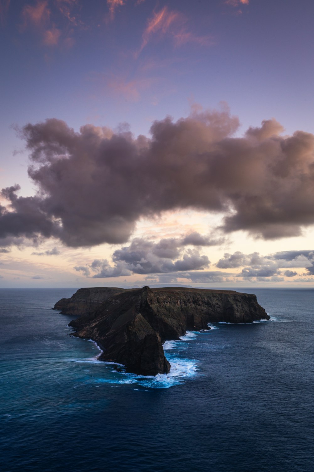 a large body of water sitting under a cloudy sky