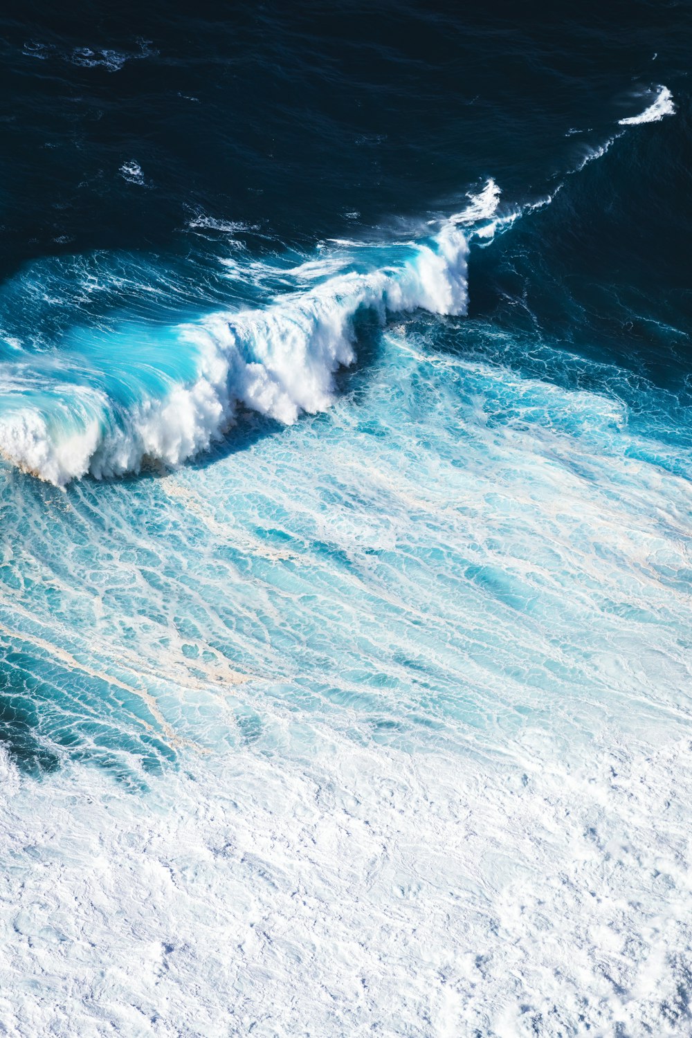 a person riding a surfboard on a wave in the ocean