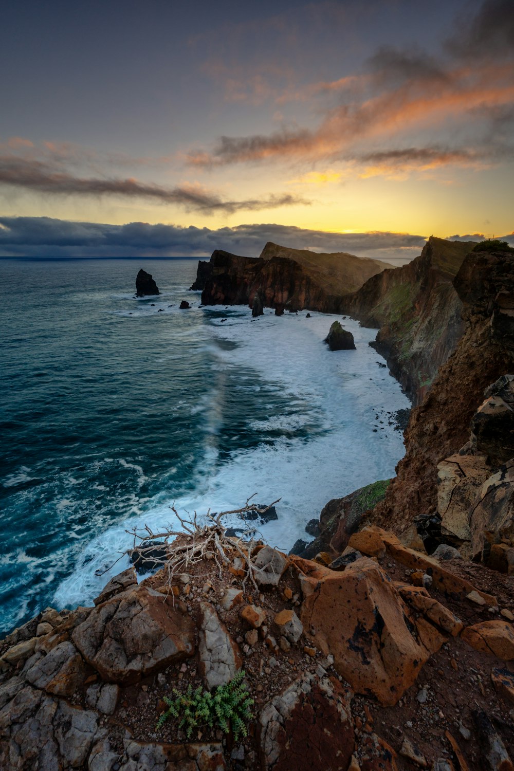 a view of the ocean from a rocky cliff