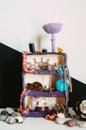 a purple suitcase with jewelry on top of it