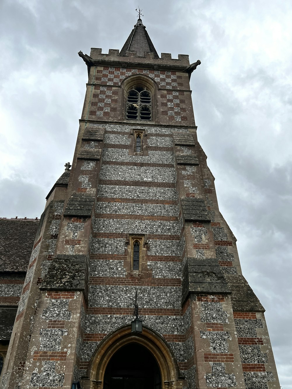 a tall brick building with a clock on it's side