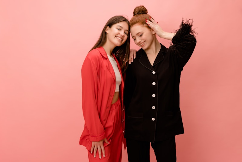 Chic duo in front of pink backdrop