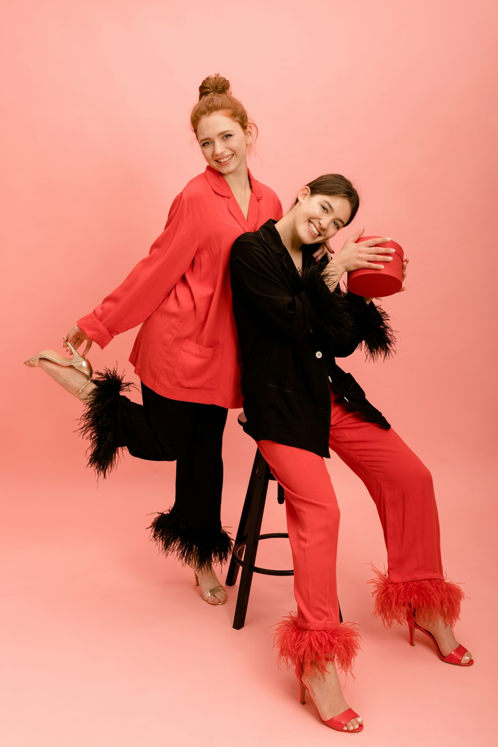 two women in red and black posing for a picture