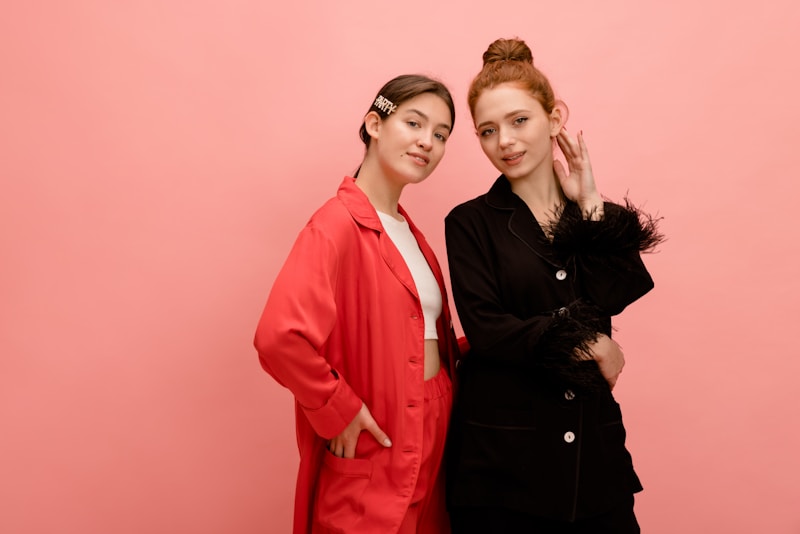 Stylish friends against pink backdrop