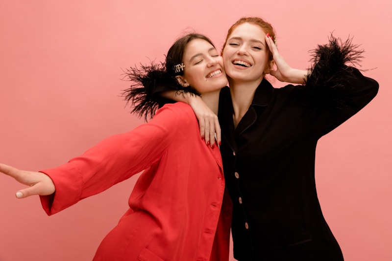 two women are hugging each other while posing for a picture