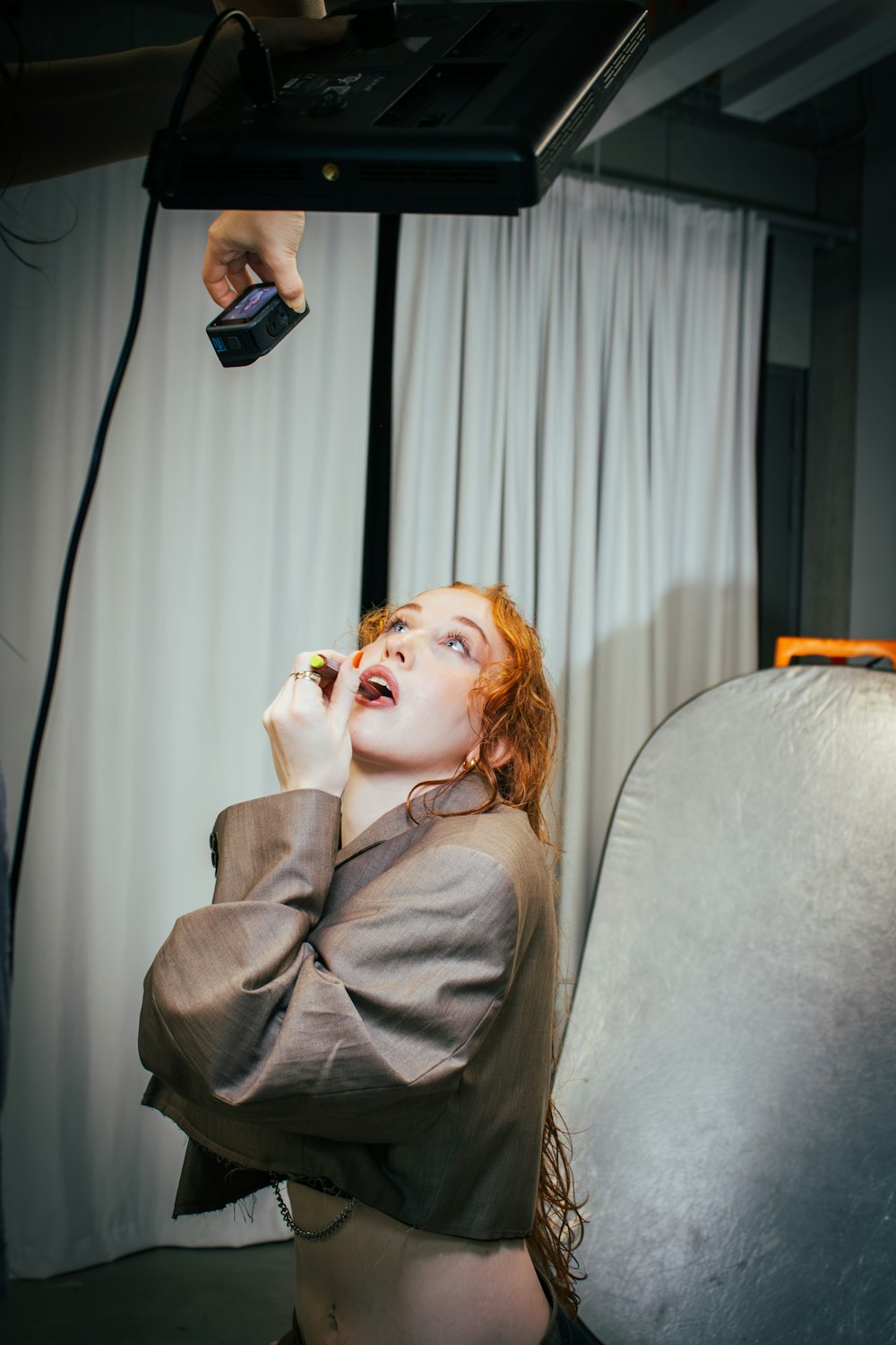 a woman sitting on a chair talking on a cell phone