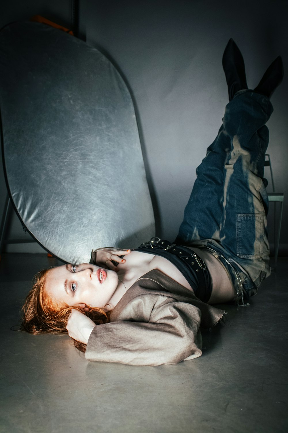 a woman laying on the floor next to a chair