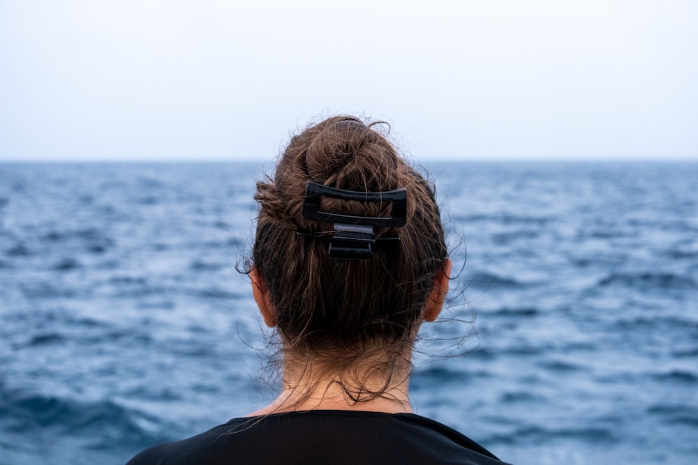 a woman looking out at the ocean from a boat