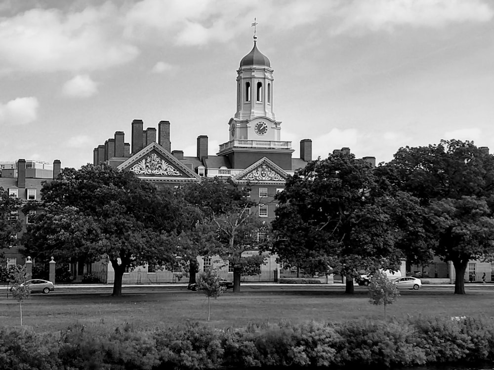 a black and white photo of a building with a clock tower