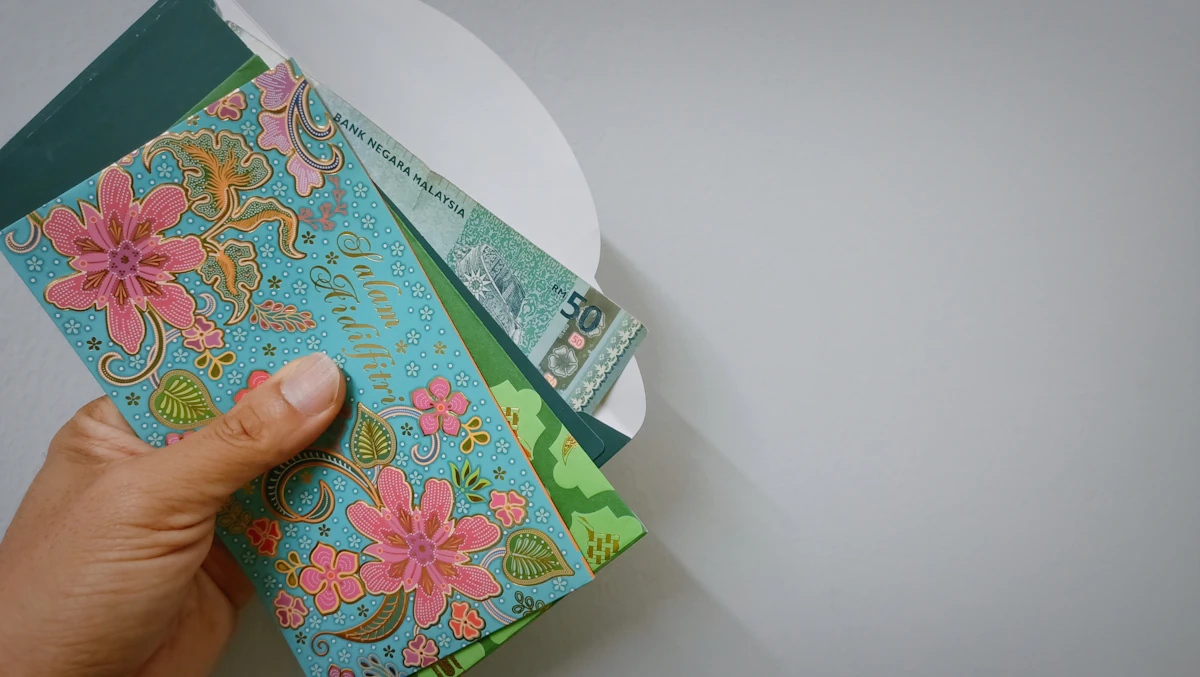A person holding a stack of cash savings