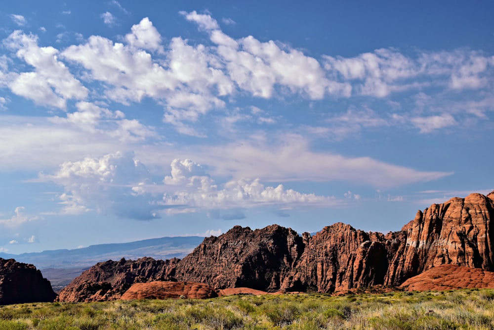 a mountain range with a few clouds in the sky