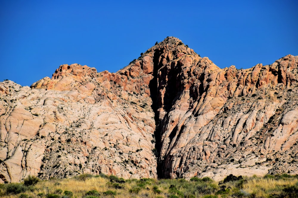 a large mountain with a very tall rock face