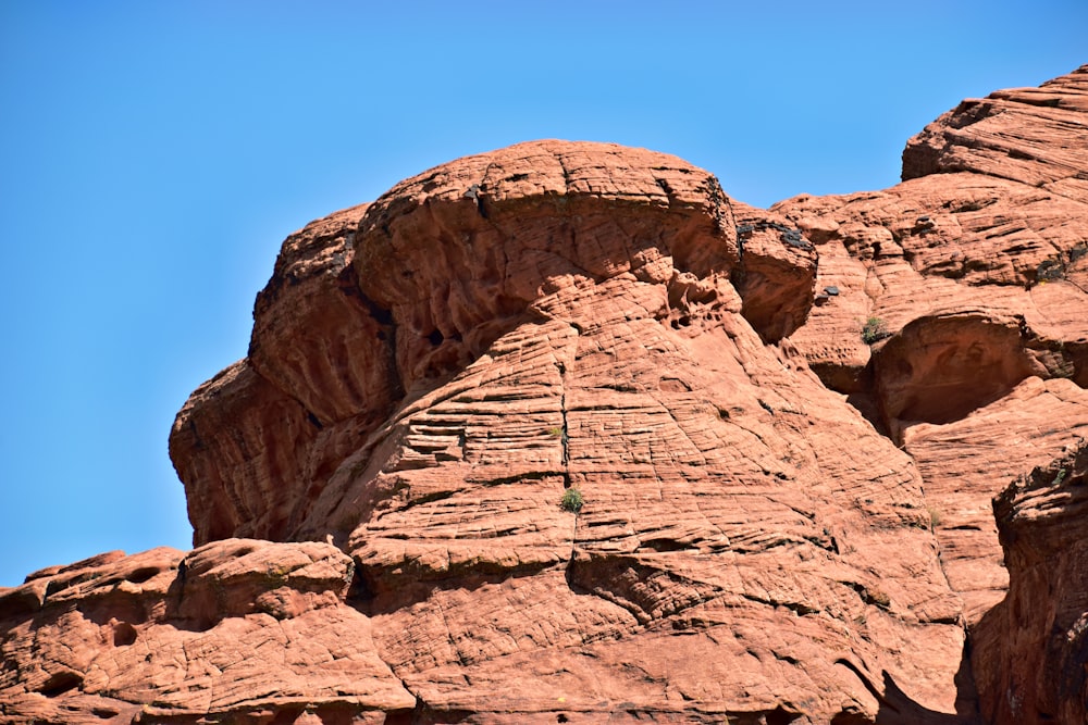 a large rock formation with a sky background