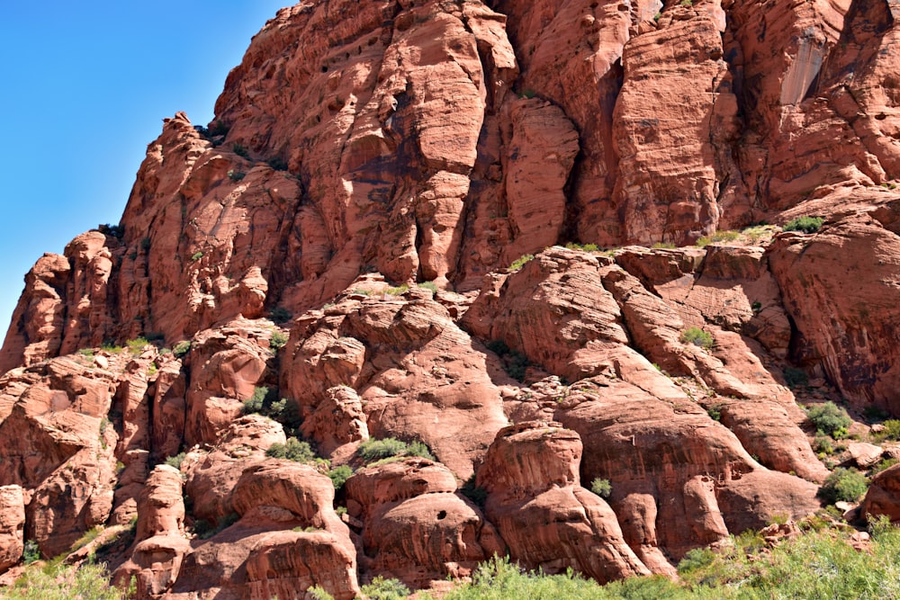 a large rock formation in the middle of a field