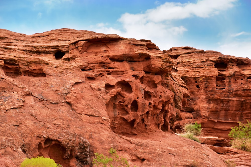 a large rock formation with small holes in it