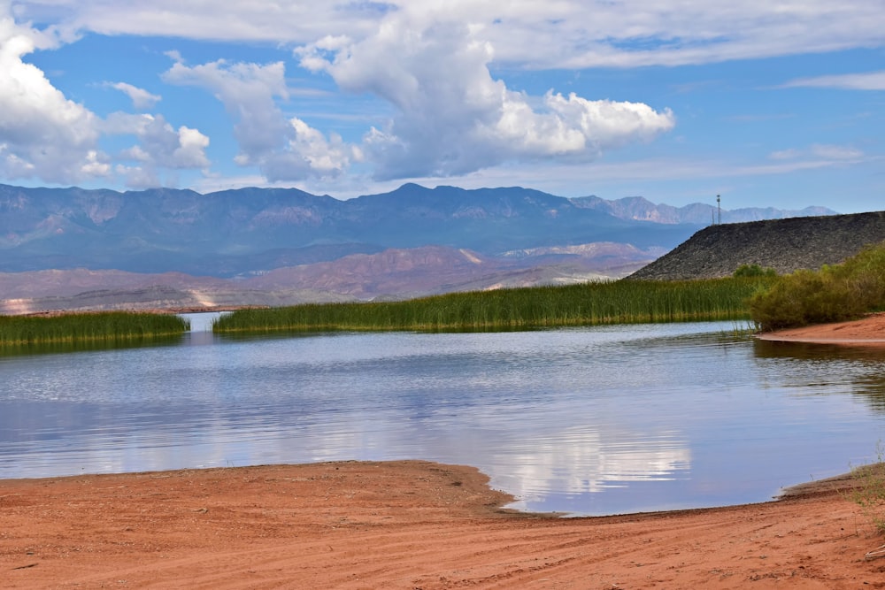 a body of water with mountains in the background