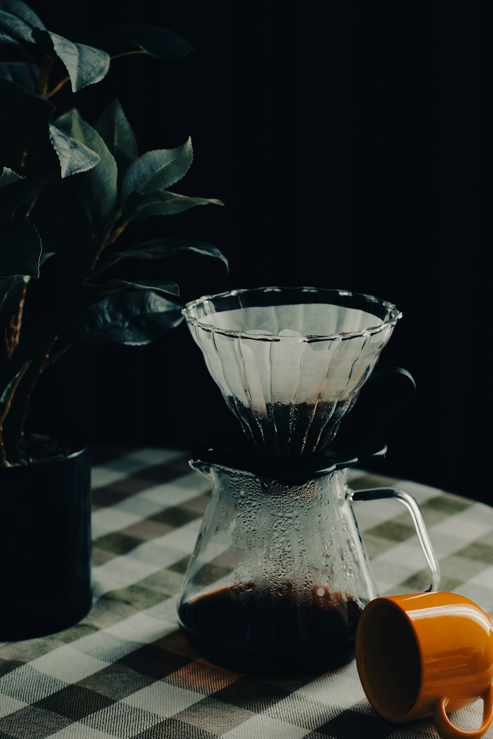 a coffee pot and a cup on a table