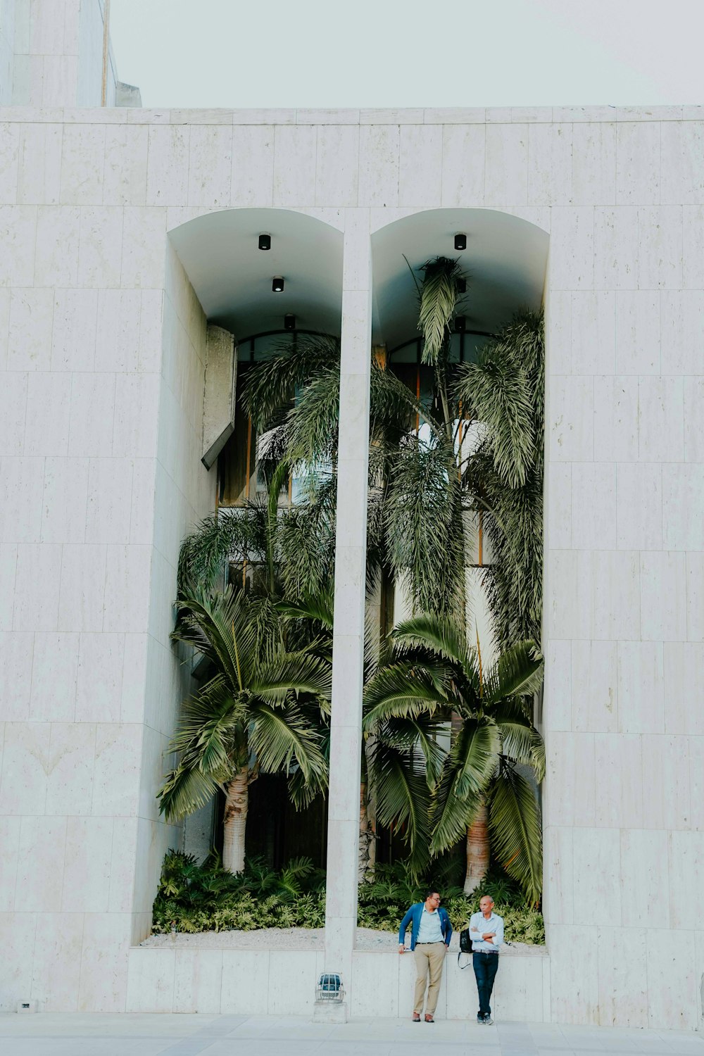 a couple of people standing in front of a building