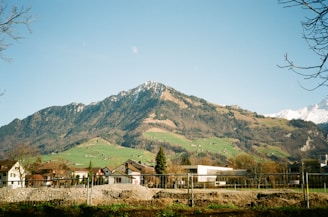 a view of a mountain with houses in the foreground